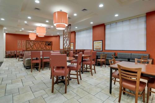 a restaurant with tables and chairs and a whiteboard at Drury Inn & Suites Charlotte Northlake in Charlotte