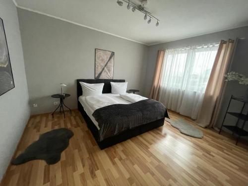 a bedroom with a bed with white sheets and a window at Heppenheimer Hof Hotel in Worms