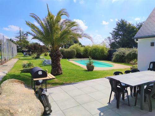 un patio avec une table, des chaises et un palmier dans l'établissement 