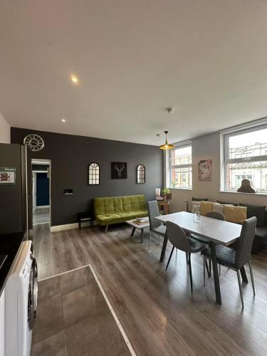 a living room with a green couch and a table at Abbey Apartments in Dublin