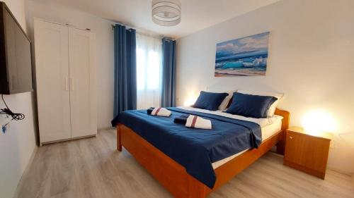 a bedroom with a bed with blue sheets and a window at Bravarica blue in Potocnica