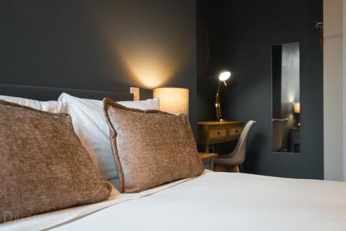 a bedroom with a white bed with two pillows at Rooms at The Dressers Arms in Chorley