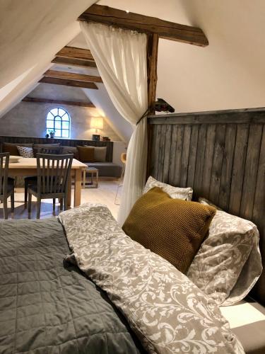 a bedroom with a bed and a dining room at Vangeled Gaard B&B - Apartments in Holtug