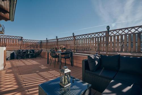a patio with a table and chairs on a balcony at Sant’Andrea Penthouse by Montenapoleone Living in Milan
