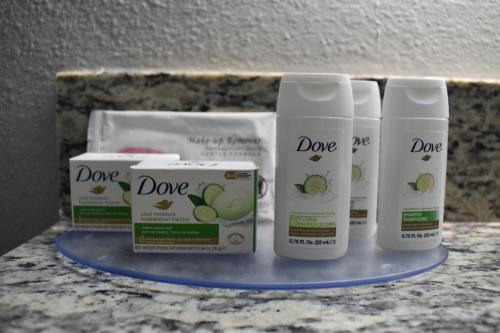 four products sitting on a counter in a bathroom at AmericInn by Wyndham Sioux City in Sioux City