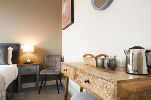 a bedroom with a table with a coffee maker on it at Rooms at The Dressers Arms in Chorley