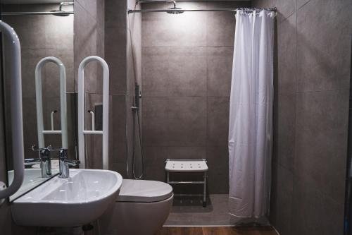 a bathroom with a sink and a toilet and a shower at Royal Apartments Bournemouth in Bournemouth