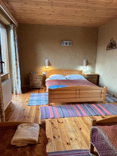 a bedroom with two beds and a wooden floor at Gospodarstwo Pytlówka Sokalski Michał in Tarczek