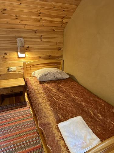 a small bedroom with a bed and a desk at Gospodarstwo Pytlówka Sokalski Michał in Tarczek