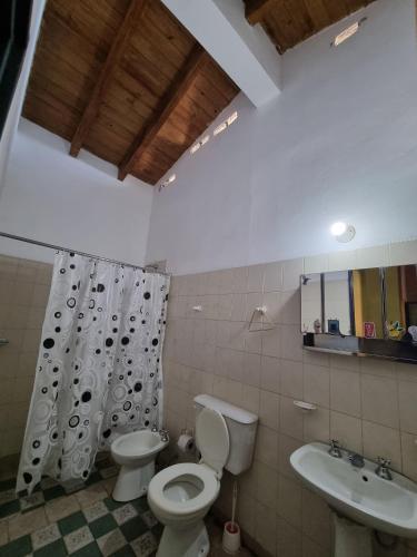 a bathroom with a toilet and a sink at CASA Costanera in Cafayate