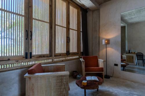 a living room with a couch and a table at El Mambo Boutique Hotel in Las Terrenas