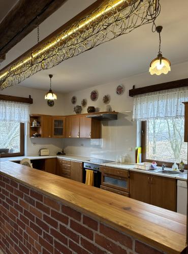 a kitchen with a brick wall and a counter top at Gospodarstwo Pytlówka Sokalski Michał in Tarczek