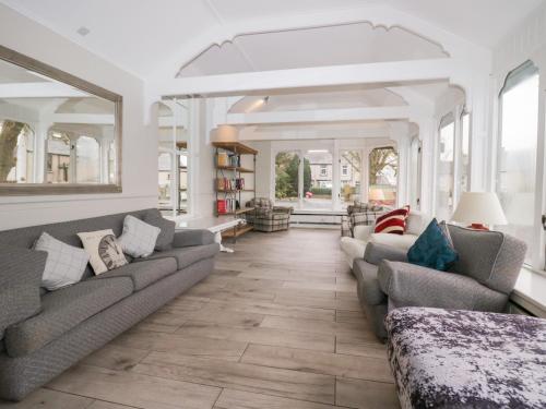 a living room with two couches and a large mirror at Valley View in Dalton in Furness