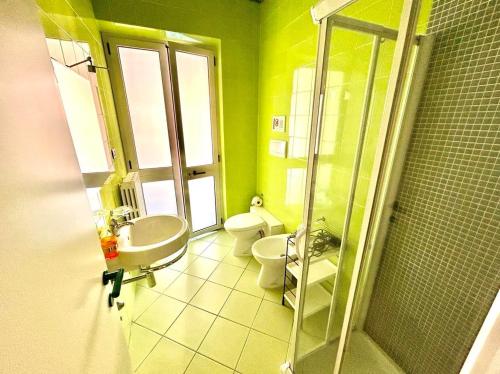 a bathroom with a sink and a toilet and a shower at MARZIO - appartamenti con terrazzo, posto auto e spiaggia in Marcelli