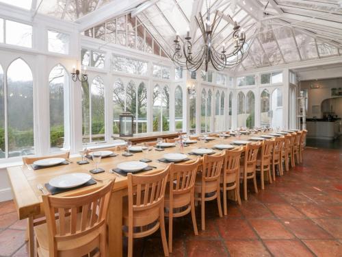 a large dining room with a long table and chairs at Valley View in Dalton in Furness