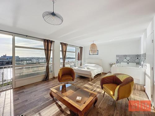 a living room with a couch and a table at La détente en amoureux in Boulogne-sur-Mer