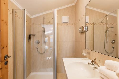 a bathroom with a shower and a sink at Familotel Kindl in Neustift im Stubaital
