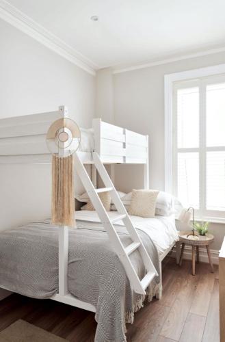 a white bedroom with a white bunk bed at Driftwood House in Bournemouth