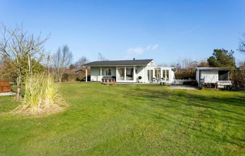 a small white house with a large yard at Cozy Home In Svendborg With Wifi in Svendborg