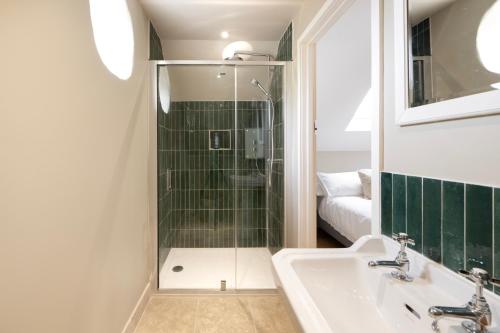 a bathroom with a shower and a sink at The Roost in Biddlestone
