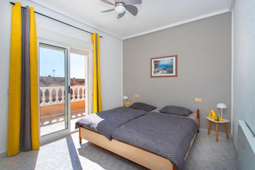 a bedroom with a bed and a large window at CH Limonero Doña Pepa in Rojales