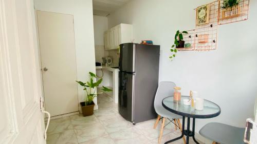 a small kitchen with a table and a refrigerator at Casa Hotel Terraza del Cabrero in Cartagena de Indias