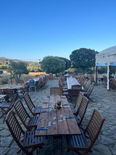 a long wooden table with chairs around it at L'Aghjalle in Santa-Reparata-di-Balagna