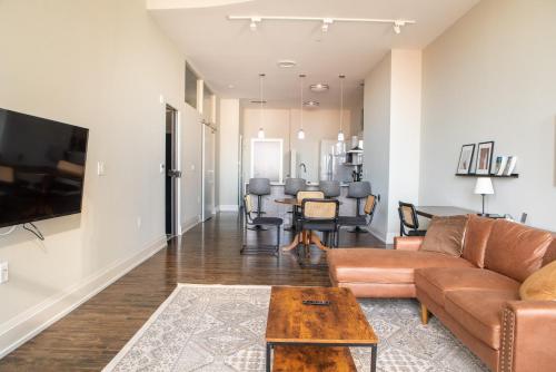 a living room with a couch and a table at Downtown Luxury 2BR Loft in Milwaukee