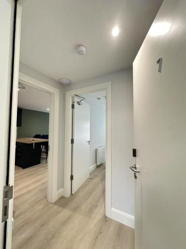 an empty hallway with a door and a room with a desk at Abbey Apartments in Dublin