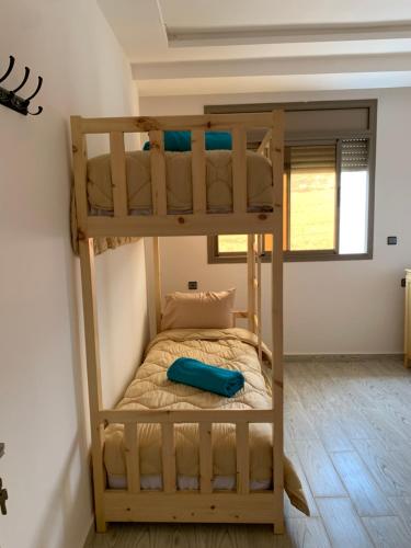 a bunk bed in a tiny house at Nomad Surf Lodge in Imsouane