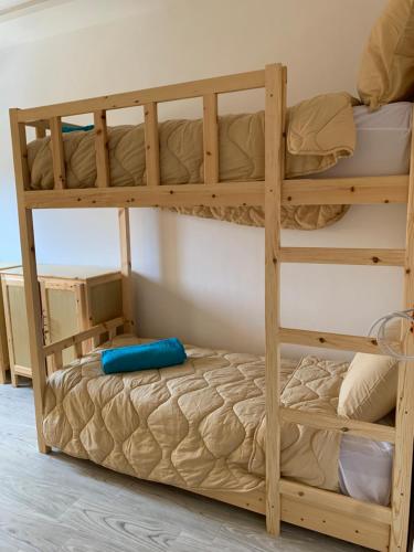a bunk bed in a room with a bunk bedutenewayangering at Nomad Surf Lodge in Imsouane