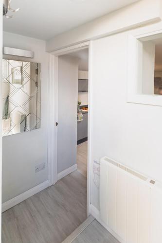 a hallway with white walls and a door at Gorgeous Boutique Flat Sleeps 2 in Lyme Regis in Lyme Regis