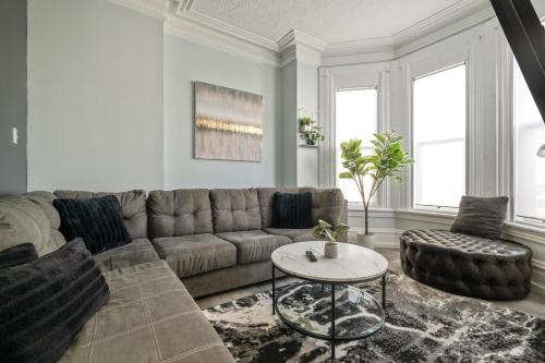 a living room with a couch and a table at Spacious Urban Gem Steps from the Pier Parking in Halifax