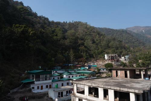 a view of a town with a mountain at Hotel Aghore Shaktipeeth in Narendranagar