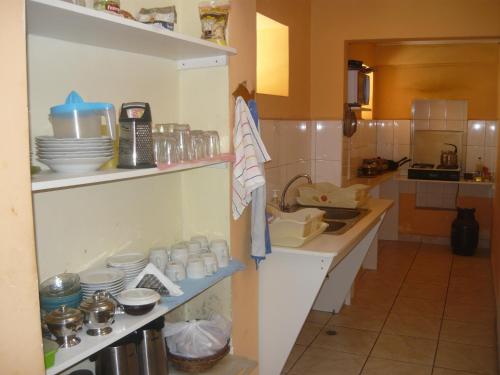 a kitchen with a sink and a counter with dishes at El Tuco Hotel in Cusco