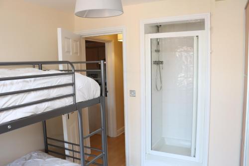 a bedroom with a bunk bed and a glass door at Scandinavian City Centre Apartment in Worcester