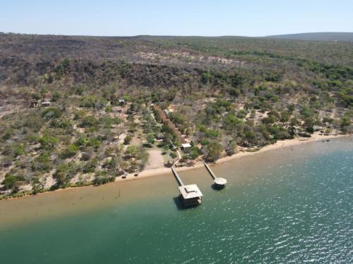an island with two boats in the water at Pousada Cocobeach Adventure - Miracema do Tocantins in Palmas