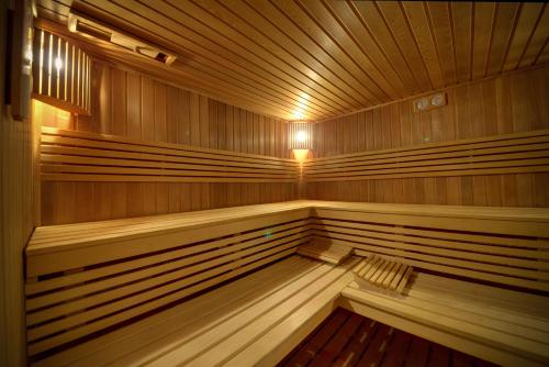 a large wooden sauna with a light in it at Rezydencja nad Wodospadem Spa&Wellness koło Szklarskiej Poręby in Szklarska Poręba