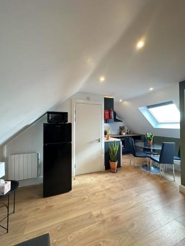 a kitchen and living room with a black refrigerator at Abbey Apartments in Dublin