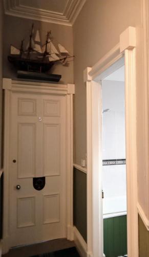 a room with a door with a boat on the wall at Greenland house in Castletown