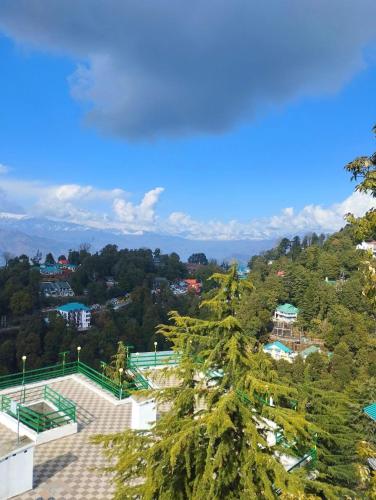 a view of a city with a tree at Aditya Homestay Dalhousie in Dalhousie