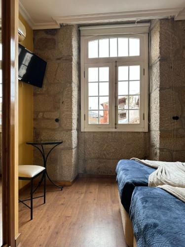 a bedroom with two beds and a window at Residencial Bem Estar in Chaves