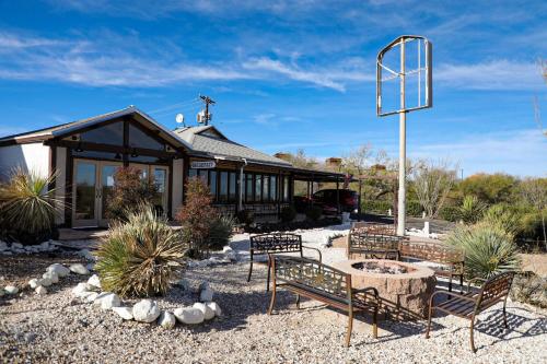 a building with chairs and a table in a yard at Landmark Lookout Lodge in Tombstone