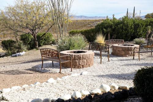 a group of benches sitting around a fire pit at Landmark Lookout Lodge in Tombstone