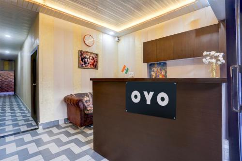 a hotel lobby with a sign on a reception desk at Super Hotel O Radha kunj By Namasya Retreat International in Prayagraj