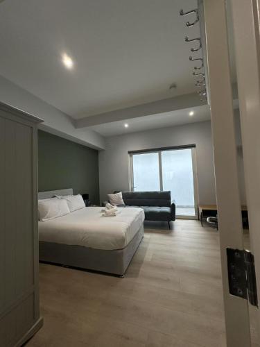 a bedroom with a bed and a couch and a window at Abbey Apartments in Dublin