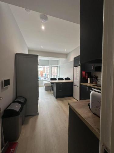 a kitchen with black and white cabinets and a table at Abbey Apartments in Dublin
