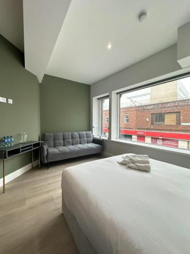 a bedroom with a large bed and a large window at Abbey Apartments in Dublin