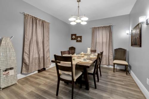 a dining room with a table and chairs at Close to Niagara Fall Dream Home in Niagara Falls
