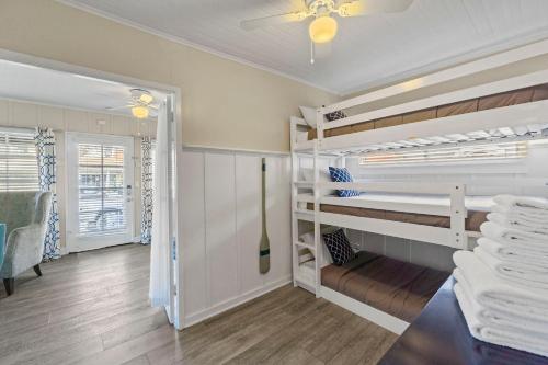 a room with bunk beds and a ceiling fan at 118 Emerald Ave A & B in Newport Beach